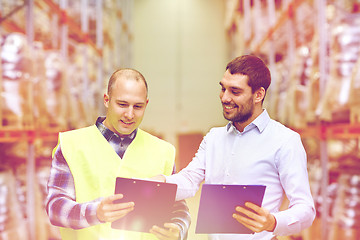 Image showing worker and businessmen with clipboard at warehouse