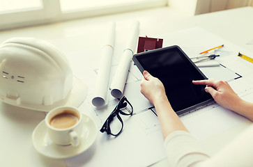 Image showing close up of hand with blueprint and tablet pc