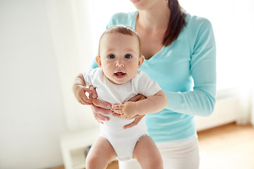 Image showing happy young mother with little baby at home