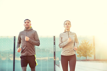 Image showing happy couple running upstairs on city stairs