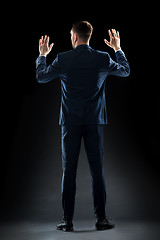 Image showing businessman in suit touching something invisible