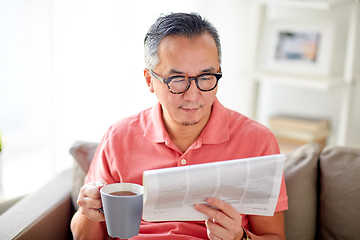 Image showing man drinking tea and reading newspaper at home