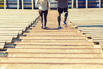 Image showing close up of couple running downstairs on stadium