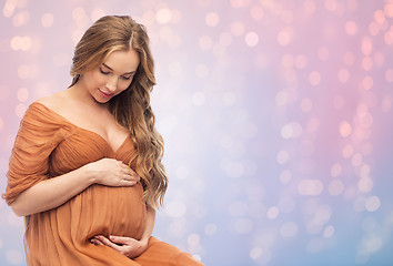 Image showing happy pregnant woman touching her big belly