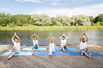 Image showing people making yoga and meditating outdoors