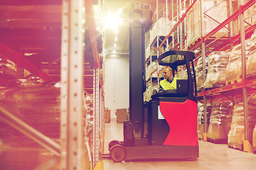 Image showing man on forklift loading cargo at warehouse