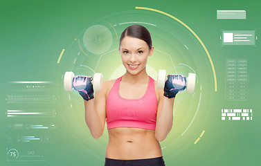 Image showing happy sporty woman with dumbbells flexing biceps