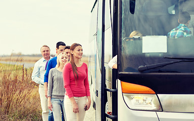 Image showing group of happy passengers boarding travel bus