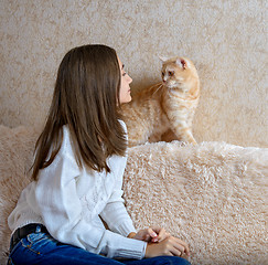 Image showing Girl and red cat