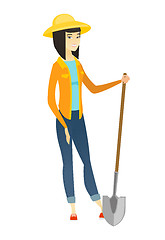 Image showing Young asian farmer holding a shovel.