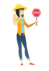 Image showing Asian farmer holding stop road sign.