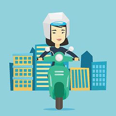 Image showing Woman riding scooter in the city.