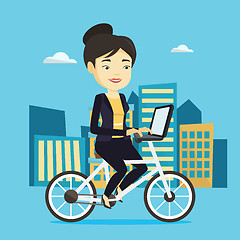 Image showing Woman riding bicycle in the city.