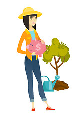 Image showing Asian farmer holding a piggy bank.