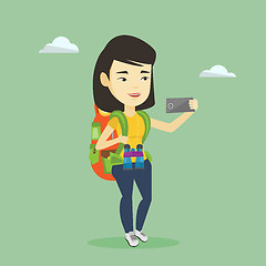 Image showing Woman with backpack making selfie.