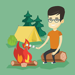 Image showing Woman roasting marshmallow over campfire.