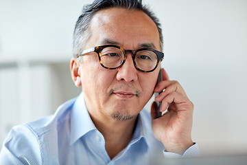 Image showing businessman calling on smartphone at office