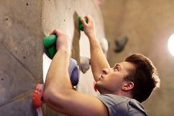 Image showing young man exercising at indoor climbing gym wall