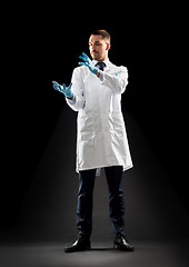 Image showing doctor or scientist in lab coat and medical gloves