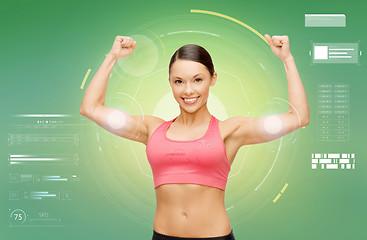 Image showing happy sporty woman showing biceps