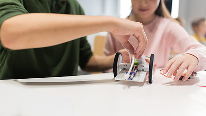 Image showing happy children building robots at robotics school