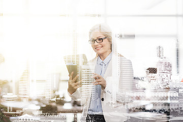 Image showing smiling businesswoman with tablet pc at office