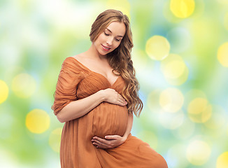 Image showing happy pregnant woman touching her big belly