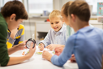 Image showing happy children building robots at robotics school