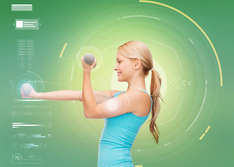 Image showing happy sporty woman with dumbbells flexing biceps