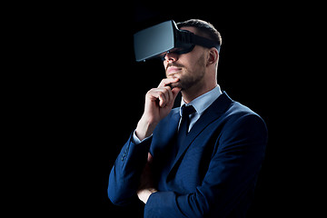 Image showing businessman in virtual reality headset over black