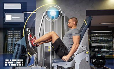 Image showing man flexing leg muscles on gym machine