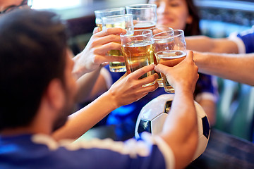 Image showing football fans clinking beer glasses at sport bar