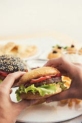 Image showing Man eating burgers