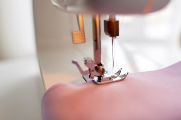 Image showing sewing machine presser foot stitching fabric