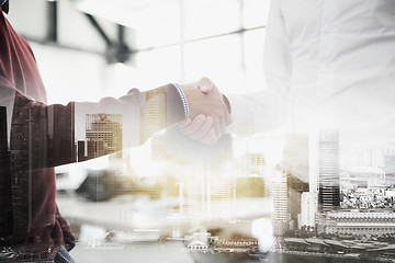 Image showing businessmen making handshake at office