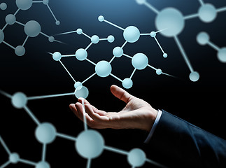 Image showing close up of businessman hand with molecule