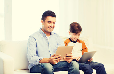 Image showing happy father and son with tablet pc at home