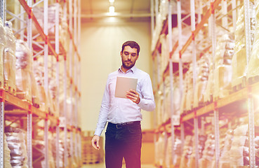 Image showing businessman with tablet pc at warehouse