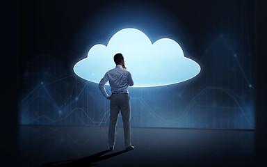 Image showing businessman at cloud projection over dark