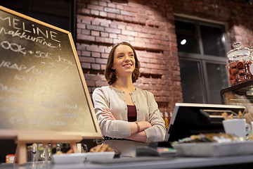 Image showing happy woman or barmaid at cafe counter