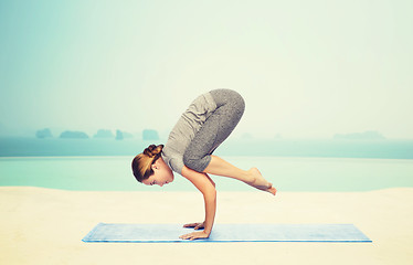 Image showing woman making yoga in crane pose on mat