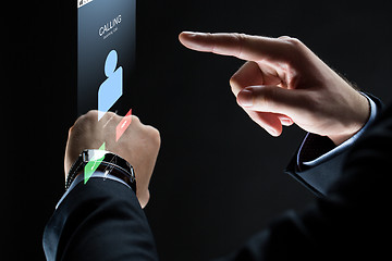 Image showing close up of businessman hands with smartwatch