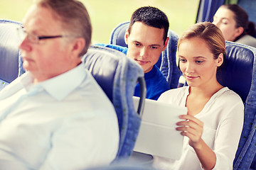 Image showing happy couple with tablet pc in travel bus