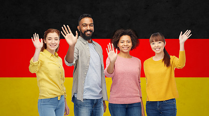 Image showing international group of happy people waving hands