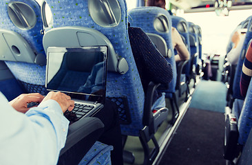 Image showing man with smartphone and laptop in travel bus