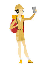 Image showing Traveler woman with backpack making selfie.