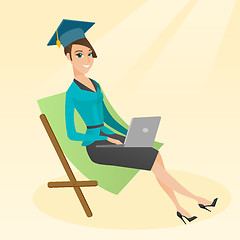 Image showing Graduate lying in chaise lounge with laptop.