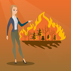 Image showing Woman standing on background of wildfire.