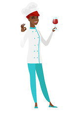 Image showing Chef holding glass of wine and showing ok sign.