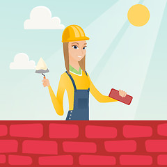 Image showing Bricklayer working with spatula and brick.